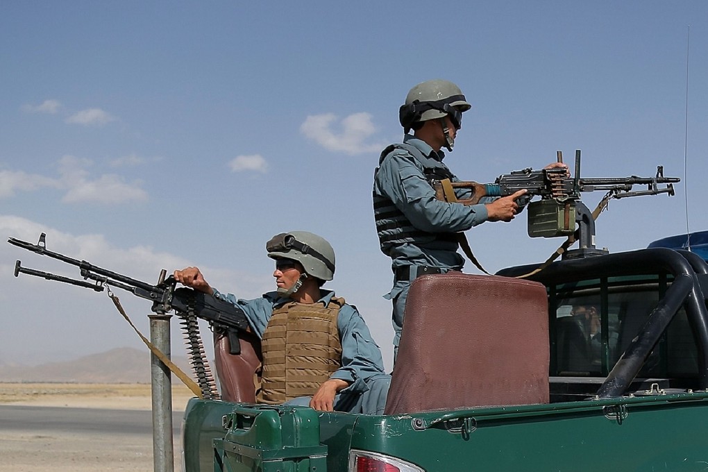 Afghan policemen keep watch at a checkpoint for Taliban militants. Insurgents killed 10 people at a construction camp in Afghanistan’s western Herat province on Saturday. Photo: AFP
