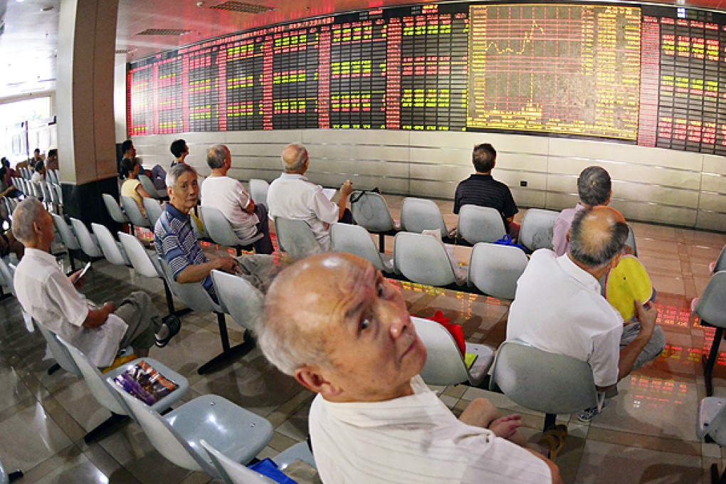 Investors follow stocks during a roller-coaster day in Shanghai. Photo: Reuters