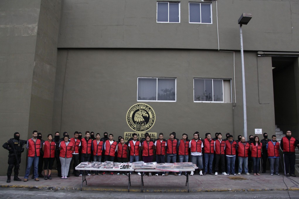 Suspected members of the Gulf Cartel (CDG) are presented to the media at the State Agency of Investigations (AEI) in November 2012. Photo: Reuters