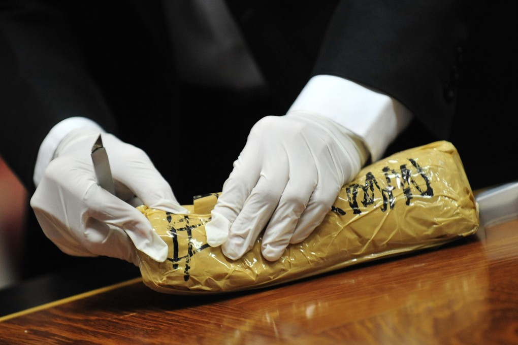 A Thai Customs official displays seized goods. Photo: Xinhua