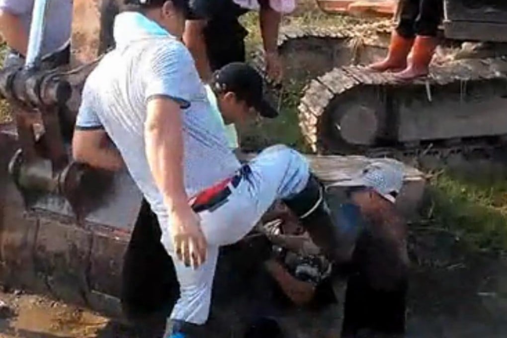 Video clip shows several men throw an elderly man into a small pond. Photo: SCMP Pictures