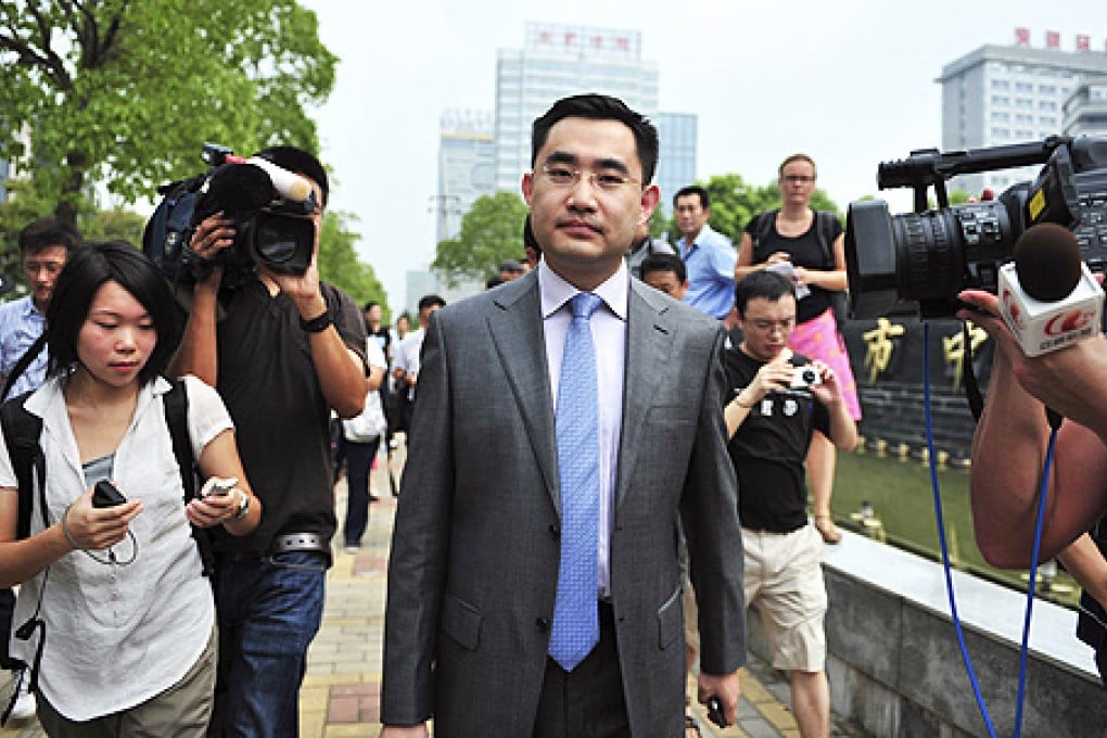 He Zhengsheng (centre), the lawyer for the family of British murder victim Neil Heywood. Photo: Reuters