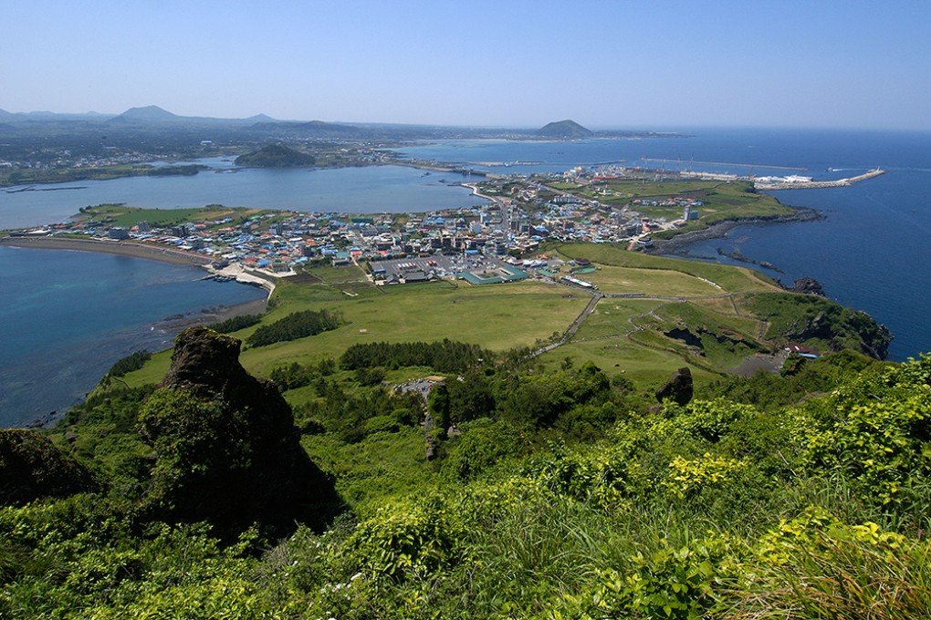 View of Seongsan village at the foot of Ilchulbong - a volcanic cone on Jeju Island, South Korea. Photo: Alamy