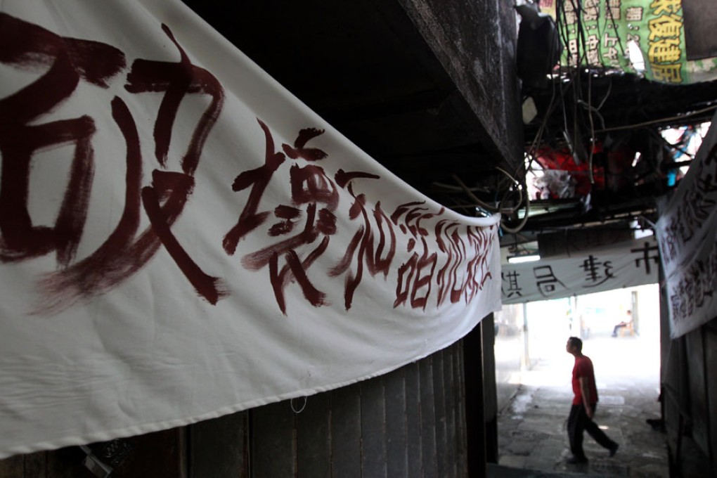 Shop owners in Yan Shun Lane affected by the Kwun Tong redevelopment project put up banners outside their shops in protest of the The Urban Renewal Authority's handling of the taking over. Photo: Nora Tam