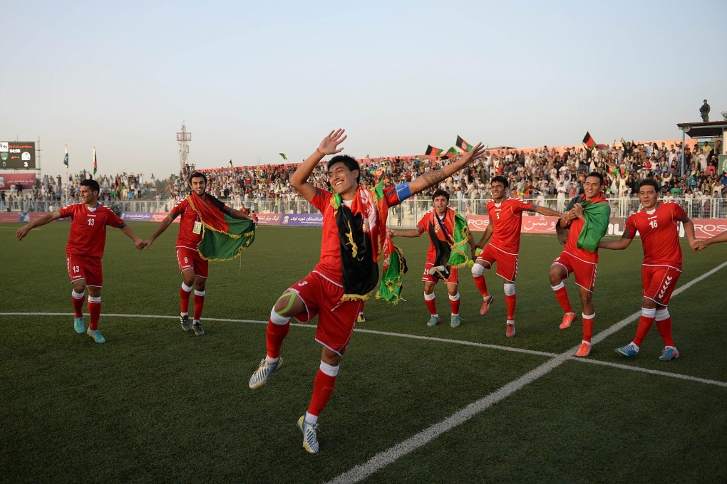 Afghan soccer team members are jubilant after their 3-0 win against arch-rival Pakistan in Kabul on Tuesday. Photo: AFP