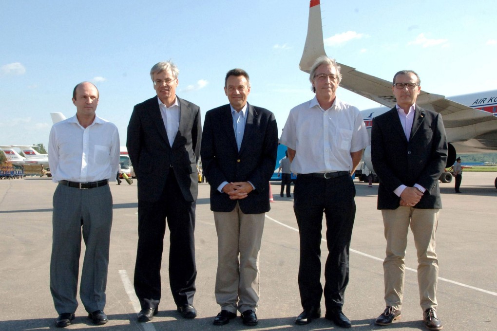 the International Committee of the Red Cross (ICRC) president Peter Maurer (C) and his delegation members arriving at Pyongyang international airport. Photo: AFP