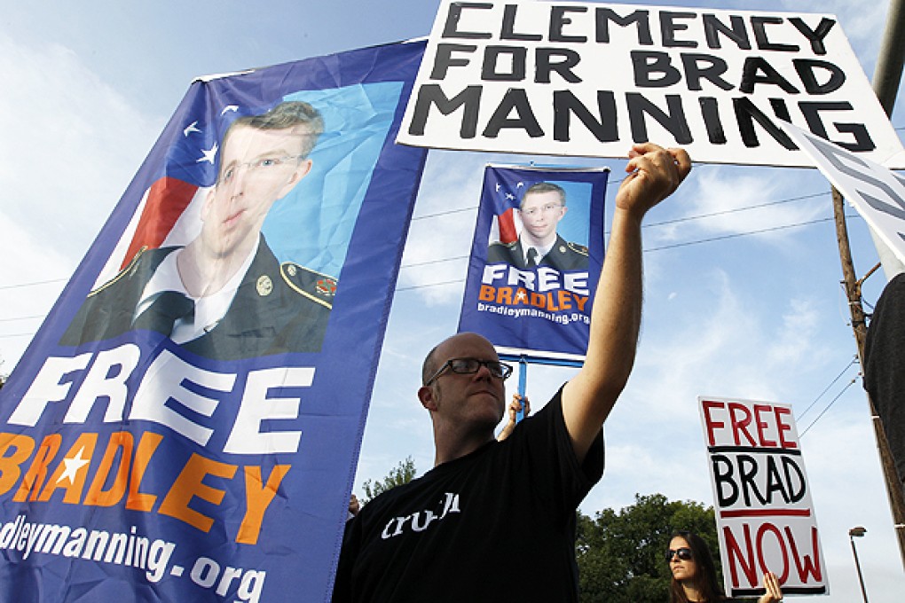 Supporters of Bradley Manning hold up banners outside of the gates at Fort Meade at Fort Meade, Maryland. Photo: AFP