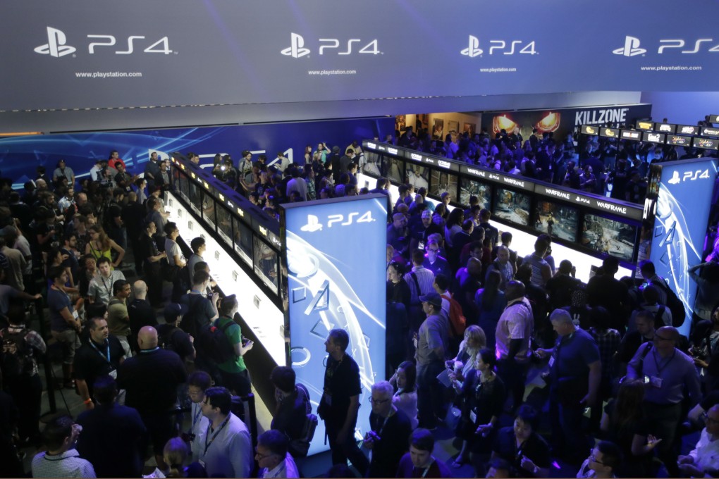 Visitors to the Electronic Entertainment Expo in Los Angeles in June test-drive the new PlayStation 4. Photo: AP