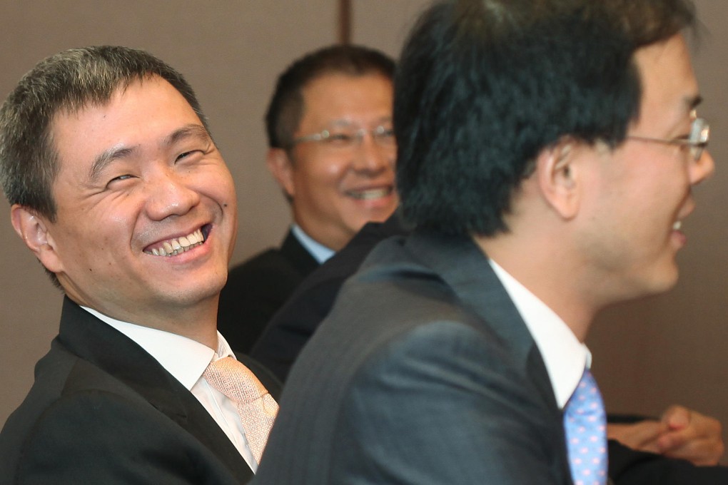 Haitong International chiefs Lin Yong (left), Wilson Hui Yee (back) and Jeff Zhang Xinjun share a light moment yesterday. Photo: Paul Yeung