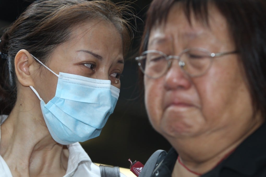 Survivor of the 2010 Manila bus shootings Yik Siu-ling and Lee Mei-chun, the mother of slain tour guide Masa Tse Ting-chunn, observe a minute's silence outside the Philippine consulate in Admiralty yesterday. Photo: Sam Tsang