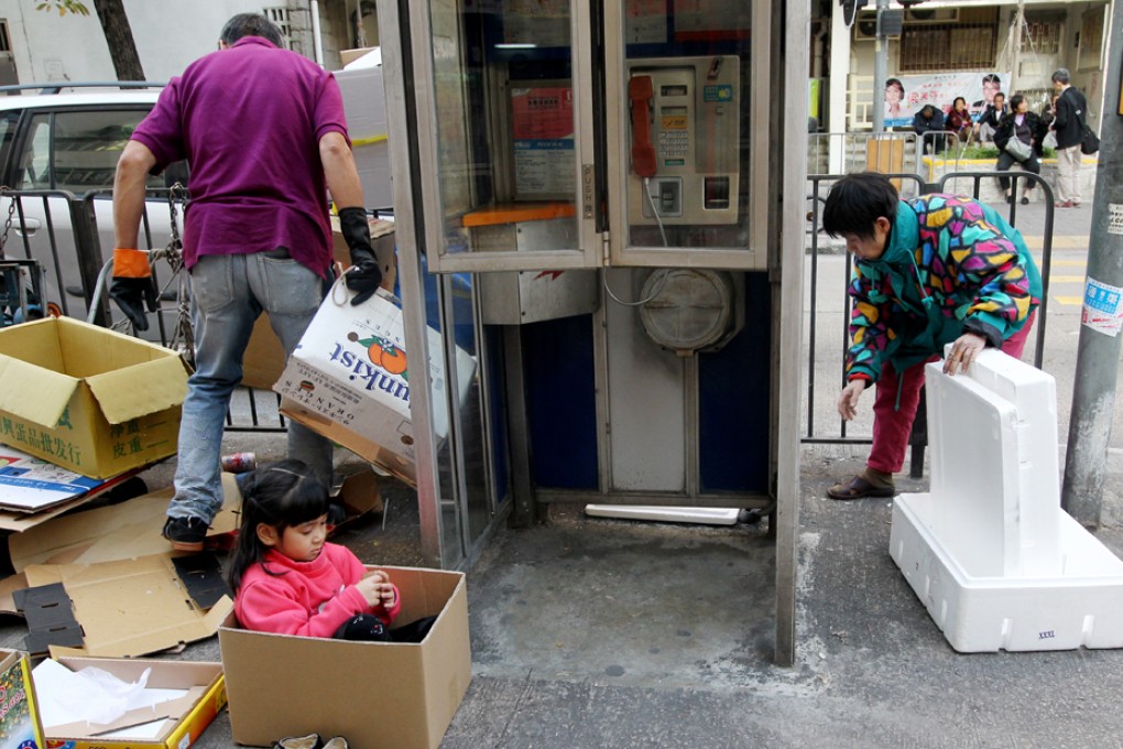 An old woman collects cardboard for cash in Causeway Bay. Photo: Felix Wong