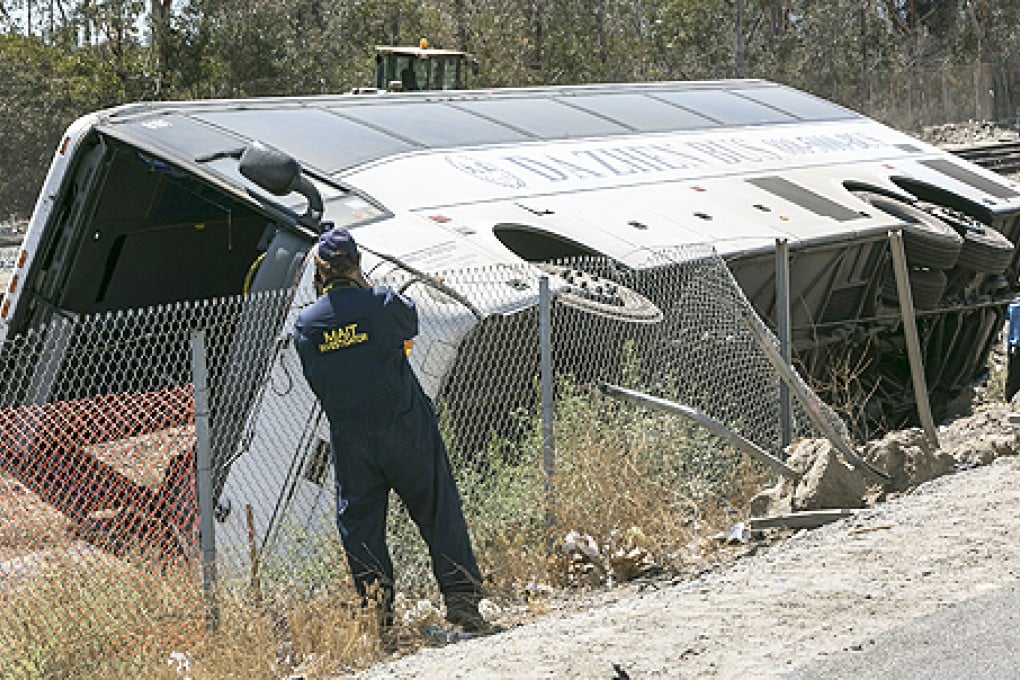 A California Highway Patrol Major Accident Investigation Team, MAIT member documents the scene of an overturned tour bus carrying gamblers to a casino on the 210 Southern California freeway, on Thursday. Photo: AP