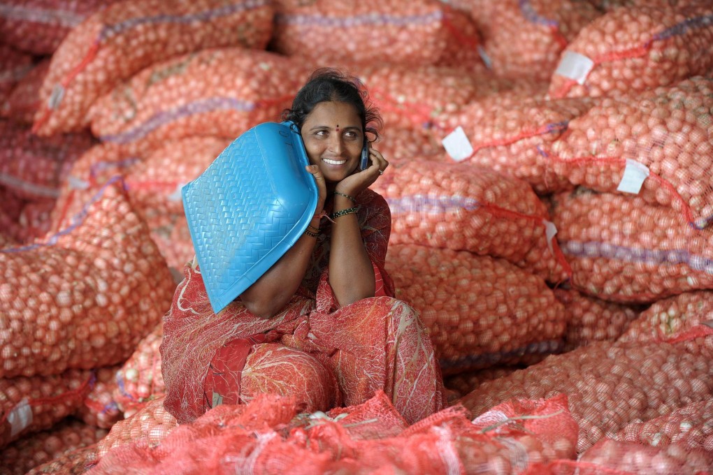 This woman obviously knows her onions, as she makes a phone call while sitting on bags at a wholesale market in Hyderabad. Photo: AFP