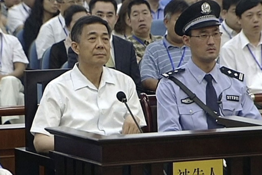 Former Chongqing chief Bo Xilai (left) sits in a court room at Jinan Intermediate People's Court in Shandong. Photo: AP