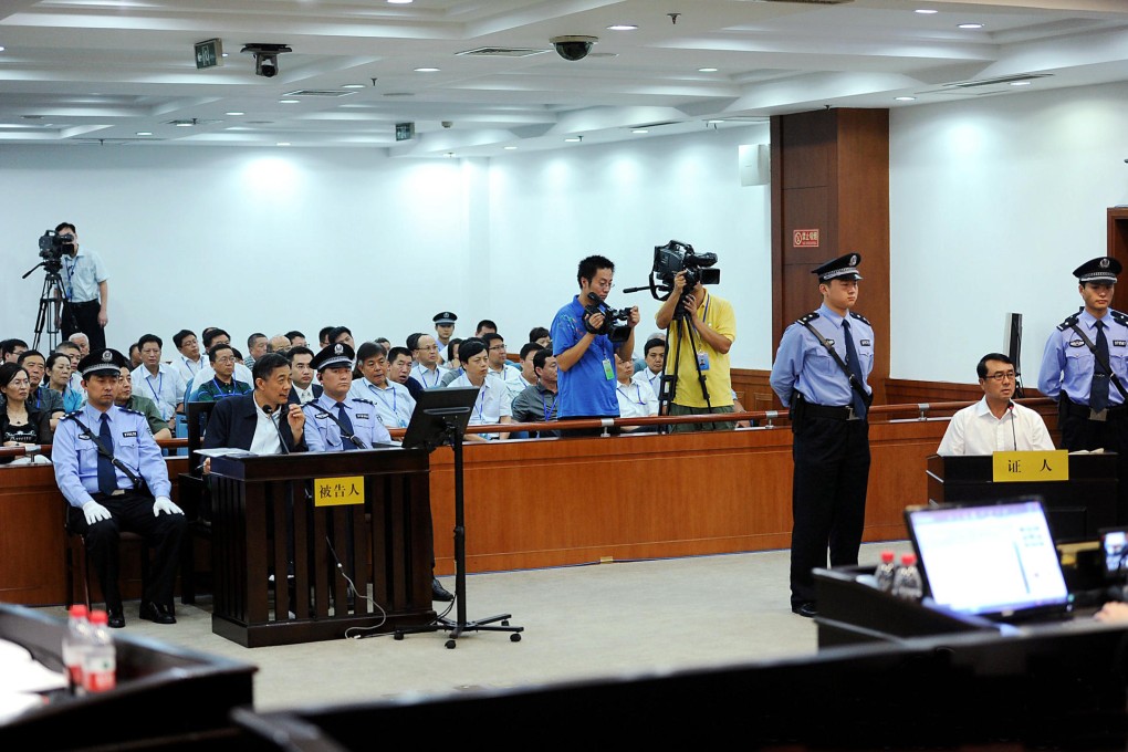 Bo Xilai (far left) looks on as his former right-hand man and Chongqing police chief Wang Lijun testifies in his trial at the Jinan Intermediate People's Court yesterday. Photo: Jinan Intermediate People's Court