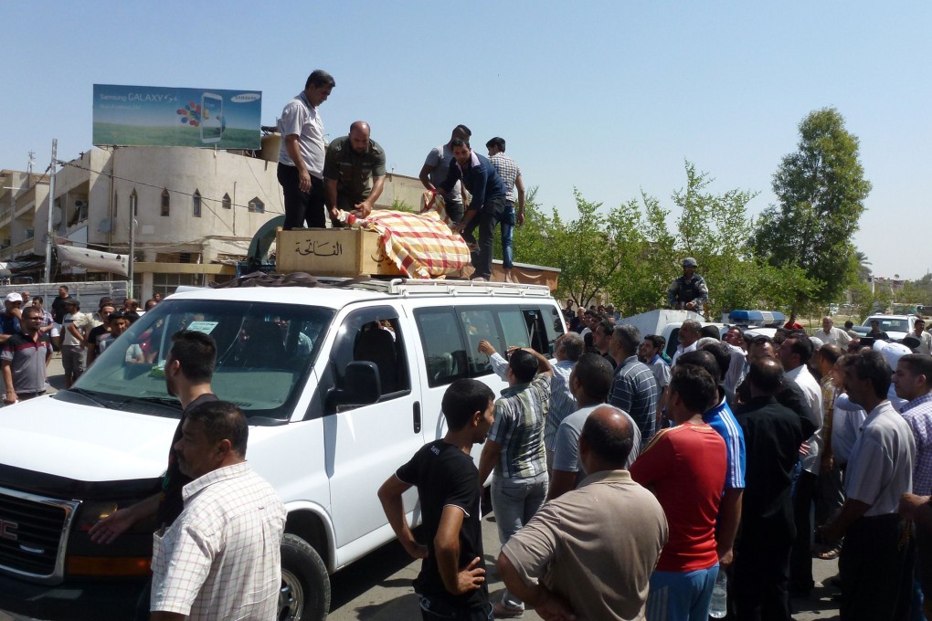 Iraqis attend the funeral of the victims of a suicide bomb attack in Baghdad's northern al-Qahira neighbourhood. Photo: AFP