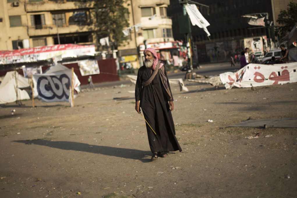 An Egyptian man walks through Tahrir Square in Cairo, Egypt, where protesters have built their camp. Photo: AP