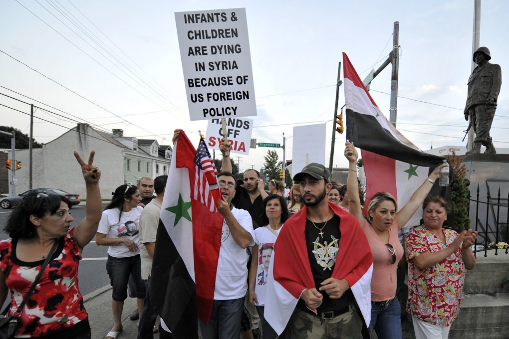 A Syrian army soldier wears a medical mask as he stands guard on a street in the Jobar neighborhood of Damascus. Photo: AP