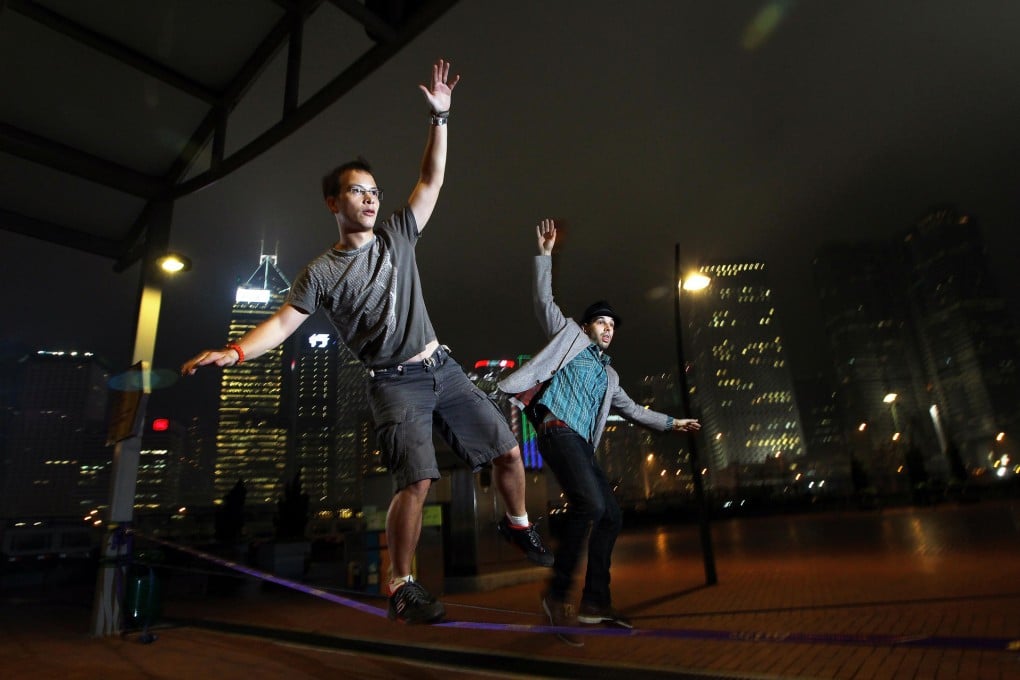 Slacklining exponents Andy Knight and Jake Erlich show their moves at the Central ferry piers. Photos: Felix Wong