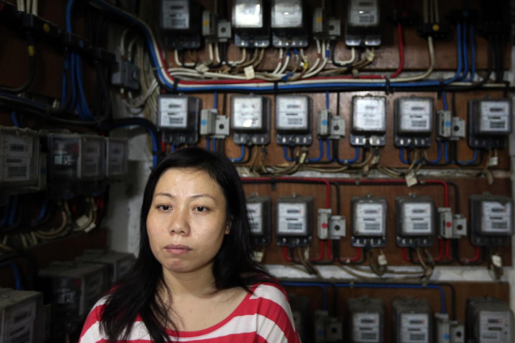 Tao Xiaorong, whose Hong Kong husband died in 2011, in the Sham Shui Po block where she lives with her son. Photo: Felix Wong