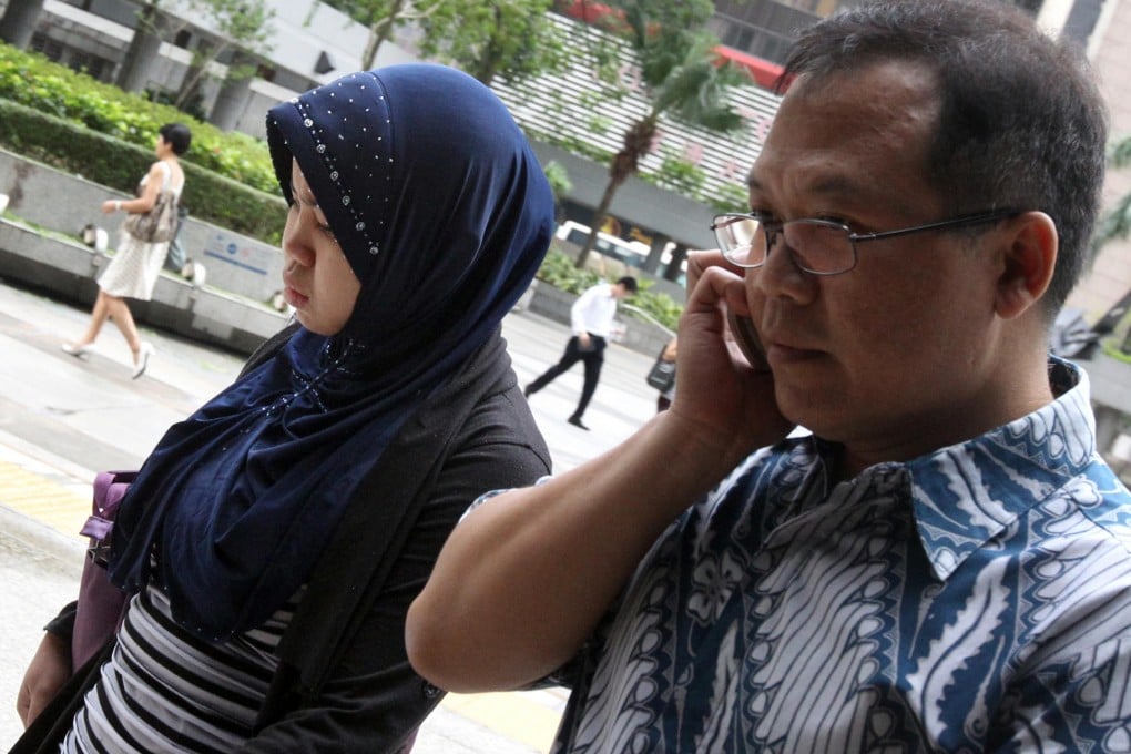Kartika Puspitasari, whose employers allegedly beat her and burned her with an iron, heads to the District Court yesterday. Photo: David Wong