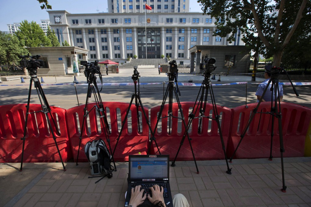 A journalist monitors a blog providing details of Bo Xilai's trial outside the Jinan Intermediate People's Court in Shandong province. Photo: AP