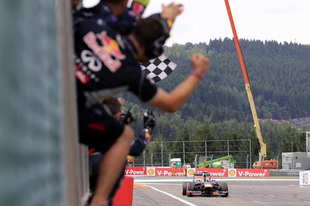 The Red Bull team celebrate as Sebastian Vettel crosses the finish line at the Spa-Francorchamps circuit. Photo: AFP