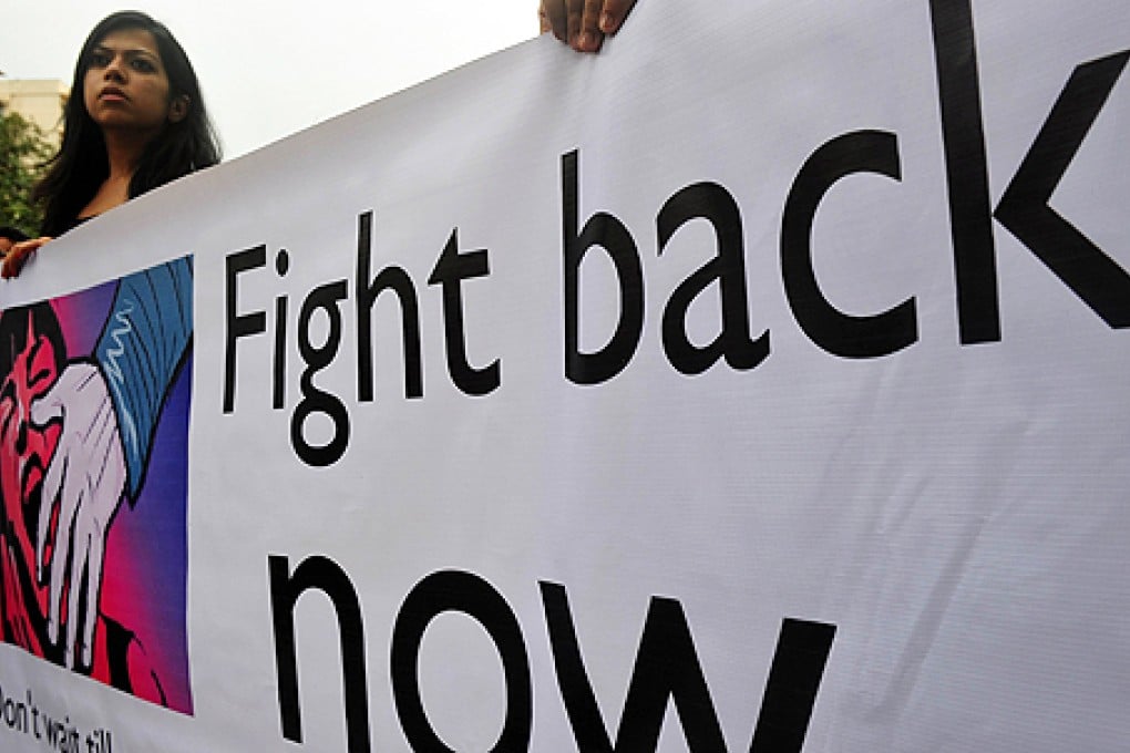 A girl holds a banner during a protest against the gang-rape of a female photographer in Mumbai on Sunday. Photo: AFP