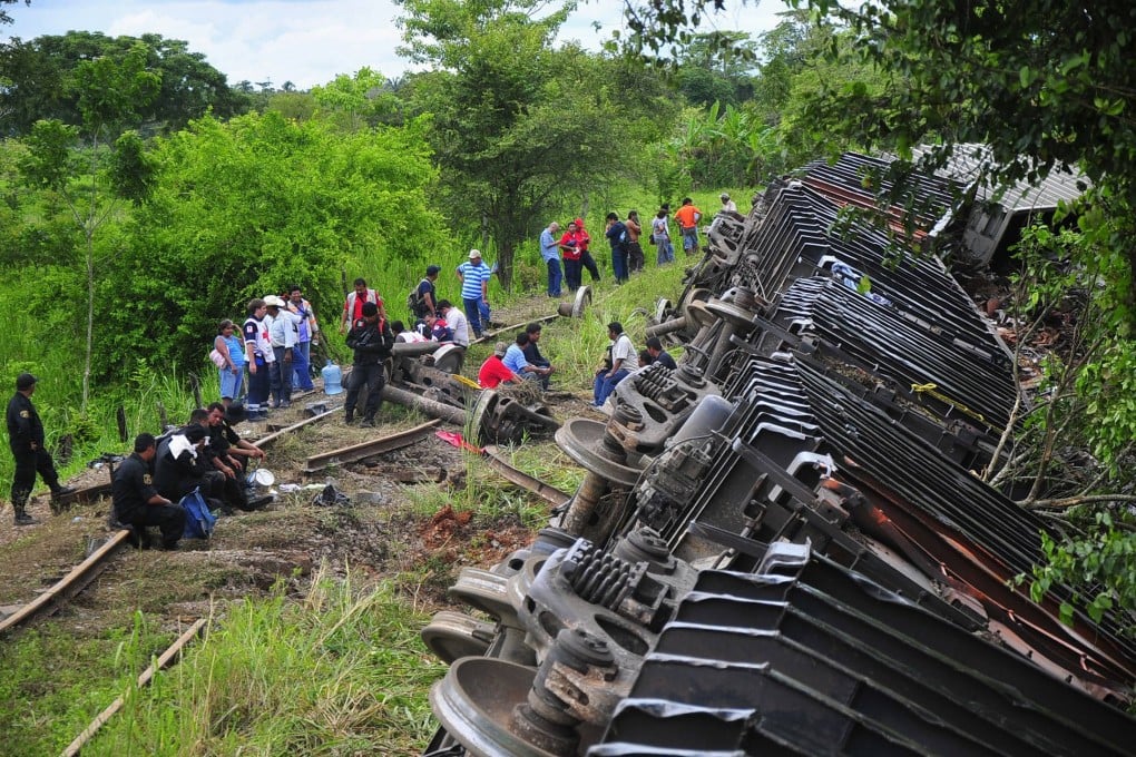 Police and rescue workers stand next to the derailed train in Huimanguillo. Photo: Reuters