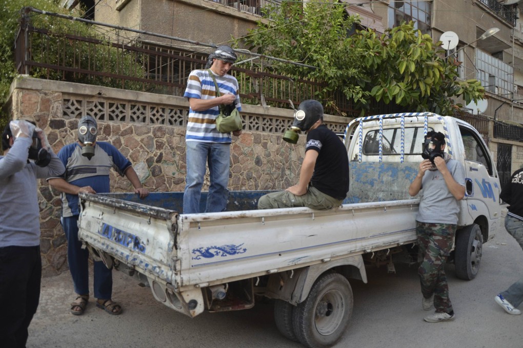 Syrian activists in Damascus wear gas masks. Photo: Reuters