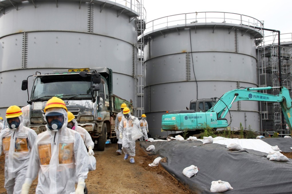 Japan's Nuclear Regulation Authority members inspects leak of storage tank. Photo: EPA