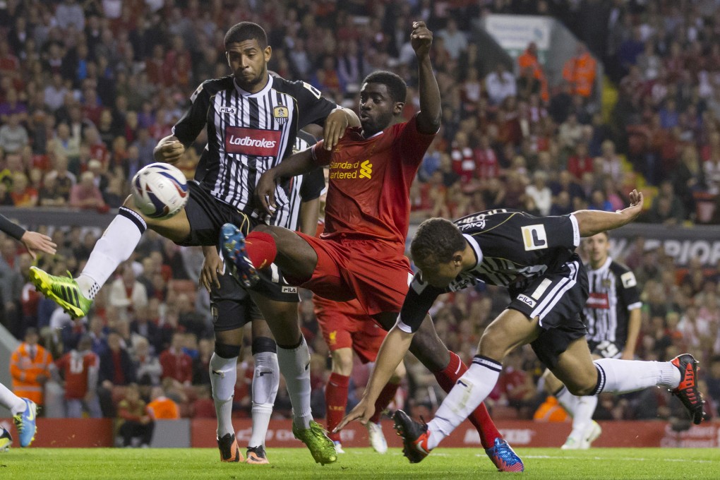 Joss Labadie and Kolo Toure vie for the ball. Photo: AP