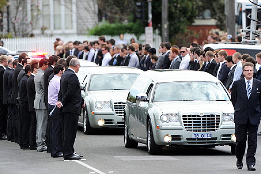 The funeral procession for Christopher Lane passes through a guard of honour as it leaves St Therese's Church in Essendon in Melbourne, Australia, on Wednesday. Photo: EPA
