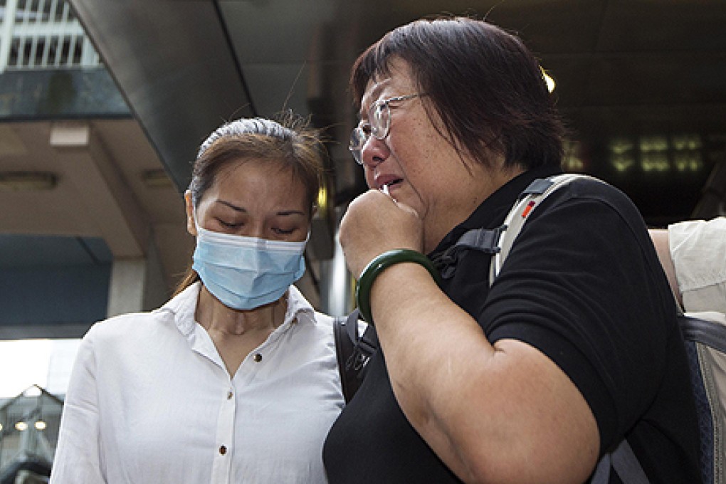 Lee Mei-chun, mother of tour guide Masa Tse who was killed in Manila's bus hostage tragedy observes a moment of silence with survivor Yik Siu-ling (left) outside the Philippine Consulate in Admiralty on Monday, the third anniversary of the deadly event.  Photo: Reuters