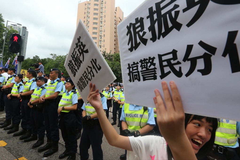 Police stand guard as Chief Executive Leung Chun-ying attends a public forum at Kwun Tong Kung Lok Government Secondary School. Photo: Felix Wong