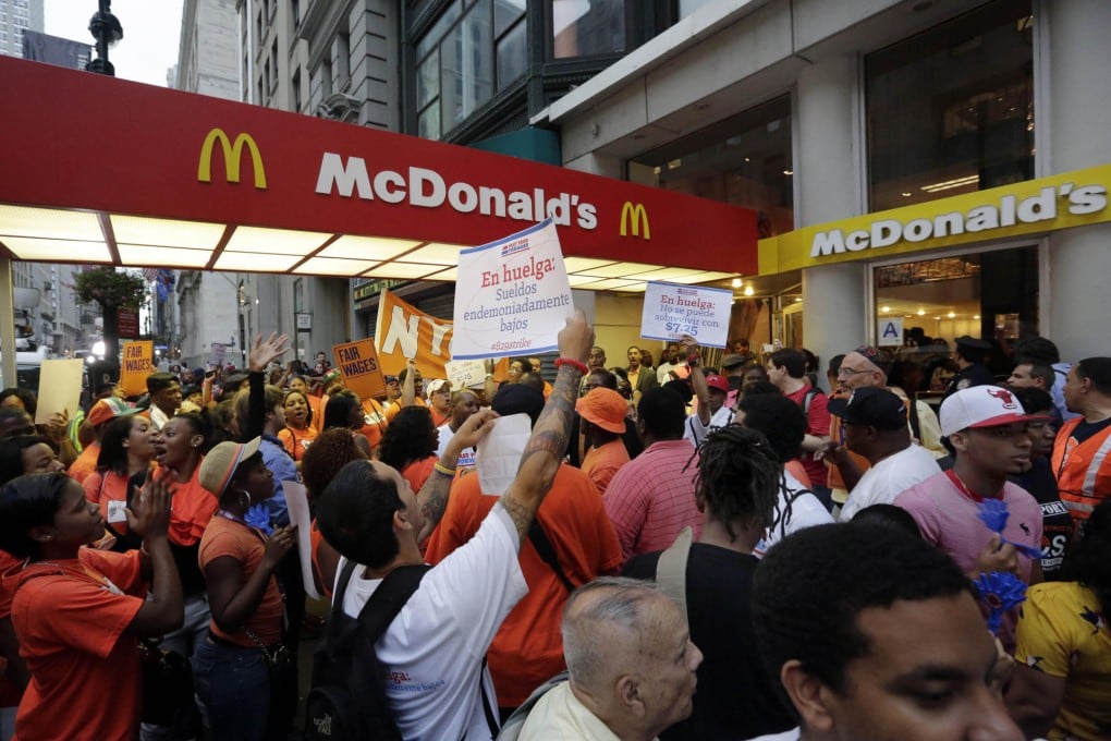 Fast food workers crowd outside a McDonald's restaurant on Fifth Avenue in New York as part of a campaign for better wages. Photo: AP