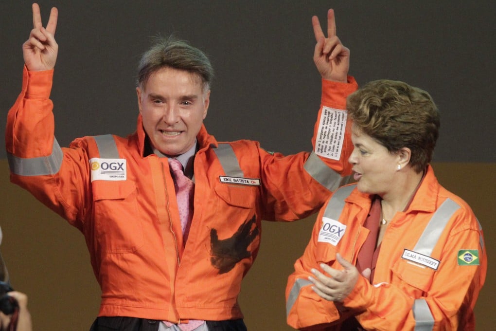 Eike Batista (left), gestures next to Brazil's President Dilma Rousseff (right) during a ceremony to mark the start of oil production of OGX in April 2012. Batista’s empire is crumbling as some of the companies he founded scramble for fresh capital. Photo: Reuters