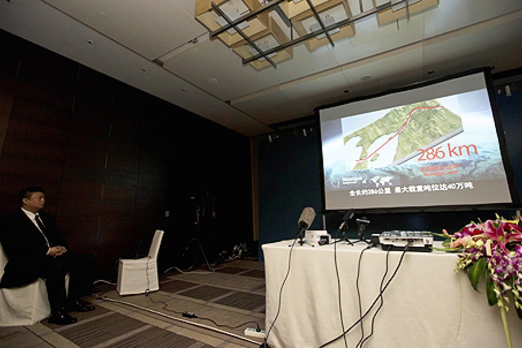 Wang Jing, chairman of Hong-Kong HKND Group watches a presentation detailing the proposed 286 kilometre long canal to be built in Nicaragua during a press conference held at a hotel in Beijing, China. Photo: AP