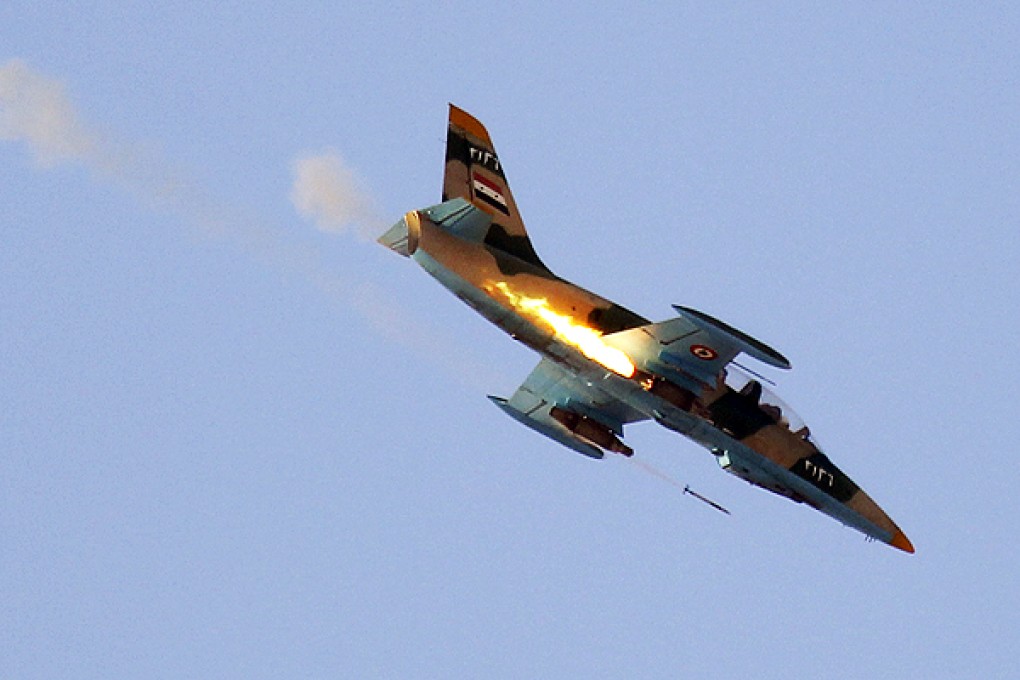 A Syrian Air Force fighter plane fires a rocket during an air strike in the village of Tel Rafat, north of Aleppo. Photo: Reuters