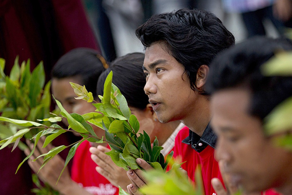 Activists pray at Shwedagon Pagoda in Yangon on the ninth month anniversary of a crackdown on protesters occupying the Letpadaung copper mine. Photo: AP