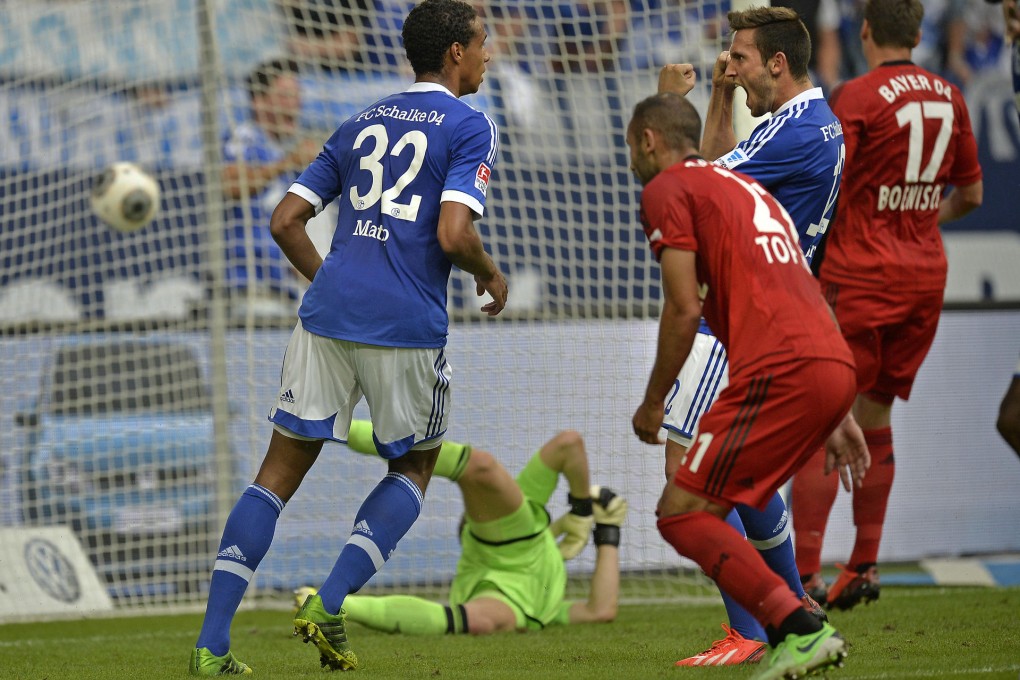 Schalke's Hoeger (right) scores against Leverkusen. Photo: AP