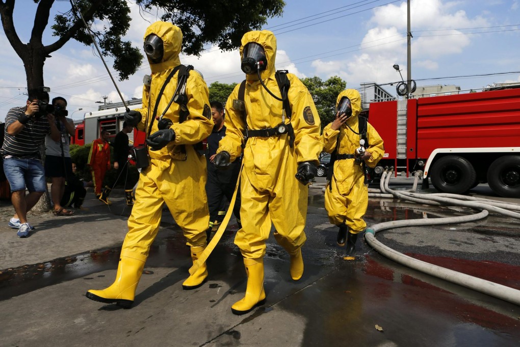 Firemen head to the site of a liquid ammonia leak. Photo: EPA