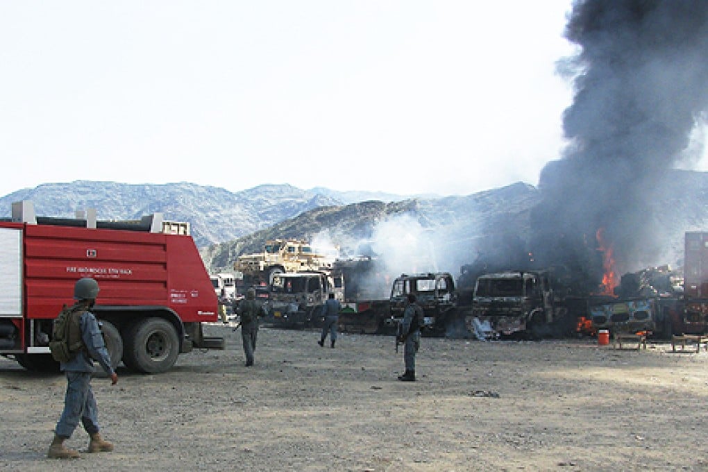 Troops survey damaged trucks at a US military base following an attack by Taliban fighters in Torkham near Afghan border with Pakistan in Nangarhar province, eastern Afghanistan, on Monday. Photo: Xinhua