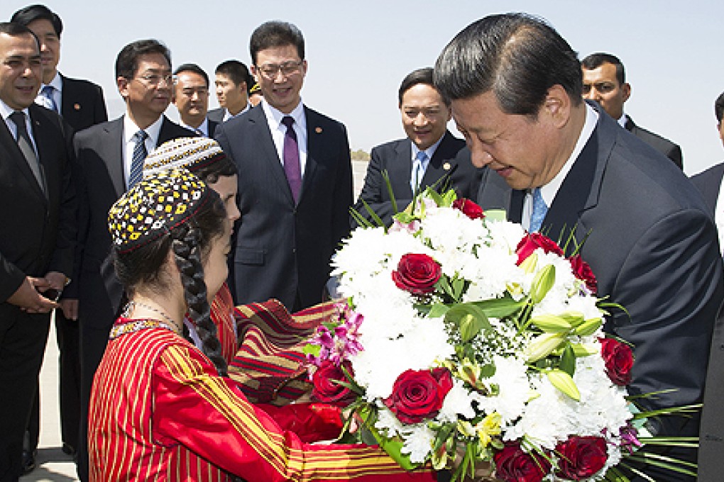President Xi Jinping is presented with flowers yesterday upon his arrival in Ashgabat. Photo: Xinhua