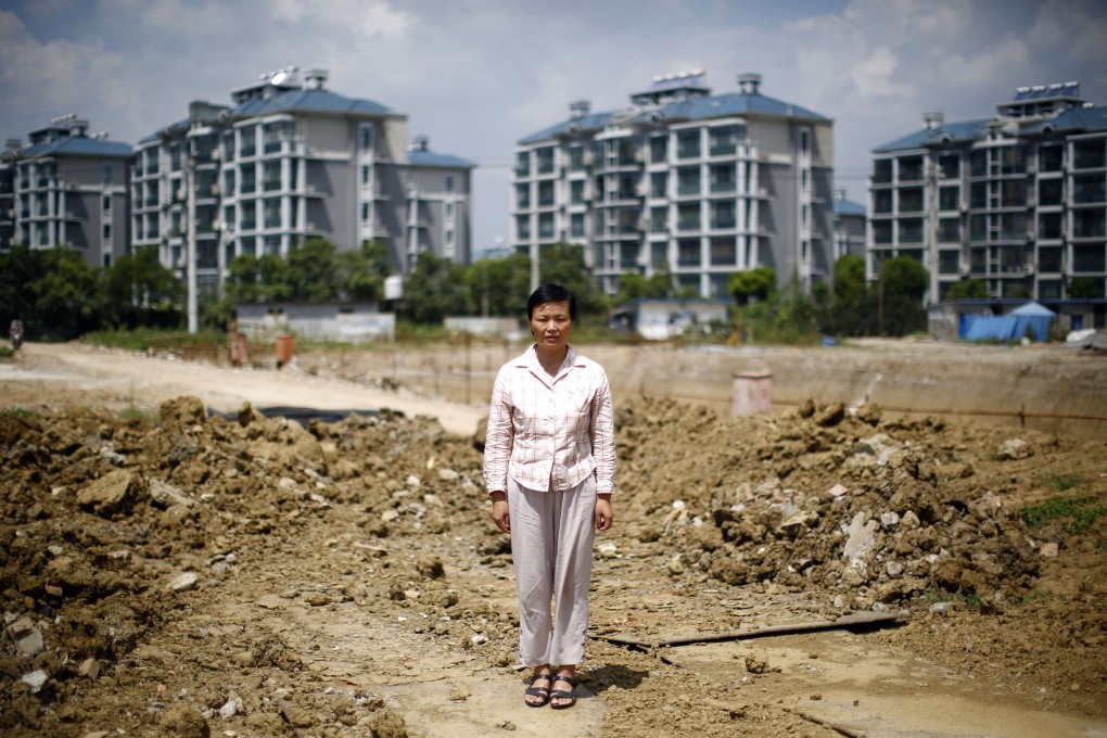 Xu Haifeng stands at a construction site in Wuxi, Jiangsu province where her house formerly stood until it was flattened three years ago. Photo: Reuters