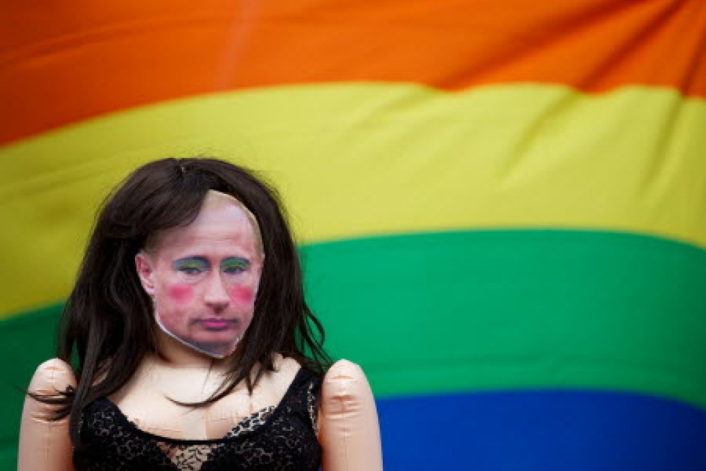 A doll with Vladimir Putin's face was seen beside a gay rights flag as protesters voiced their concerns about the Russian government's anti-gay laws in London. Photo: AFP