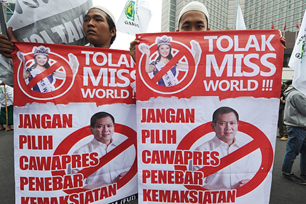 Indonesian Muslim protesters hold banners that read 'Reject Miss World' during a protest in Jakarta on Tuesday. Photo: AFP