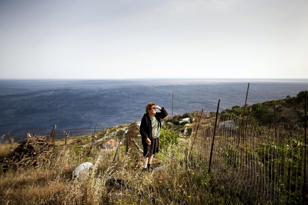 Young Ionna Meli, just 80, looks out from the village of Nas across the "blue zone" she calls home: Ikaria. Photos: Guardian News & Media