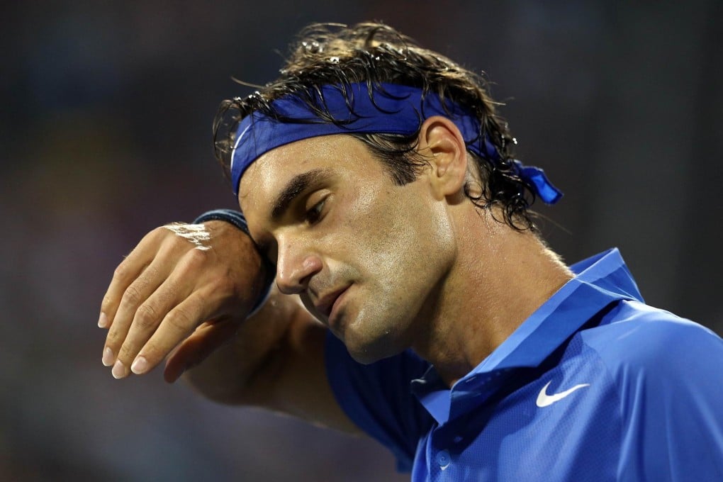 Roger Federer wipes his brow and looks resigned to defeat during his fourth-round match against Spain's Tommy Robredo at the US Open. The Swiss legend lost in straight sets. Photo: AFP