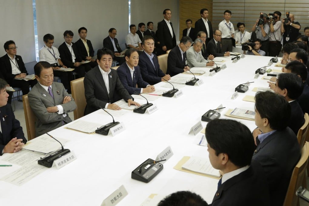 Shinzo Abe addresses a Nuclear Emergency Response Headquarters and Nuclear Power Disaster Management Council meeting. Photo: Reuters